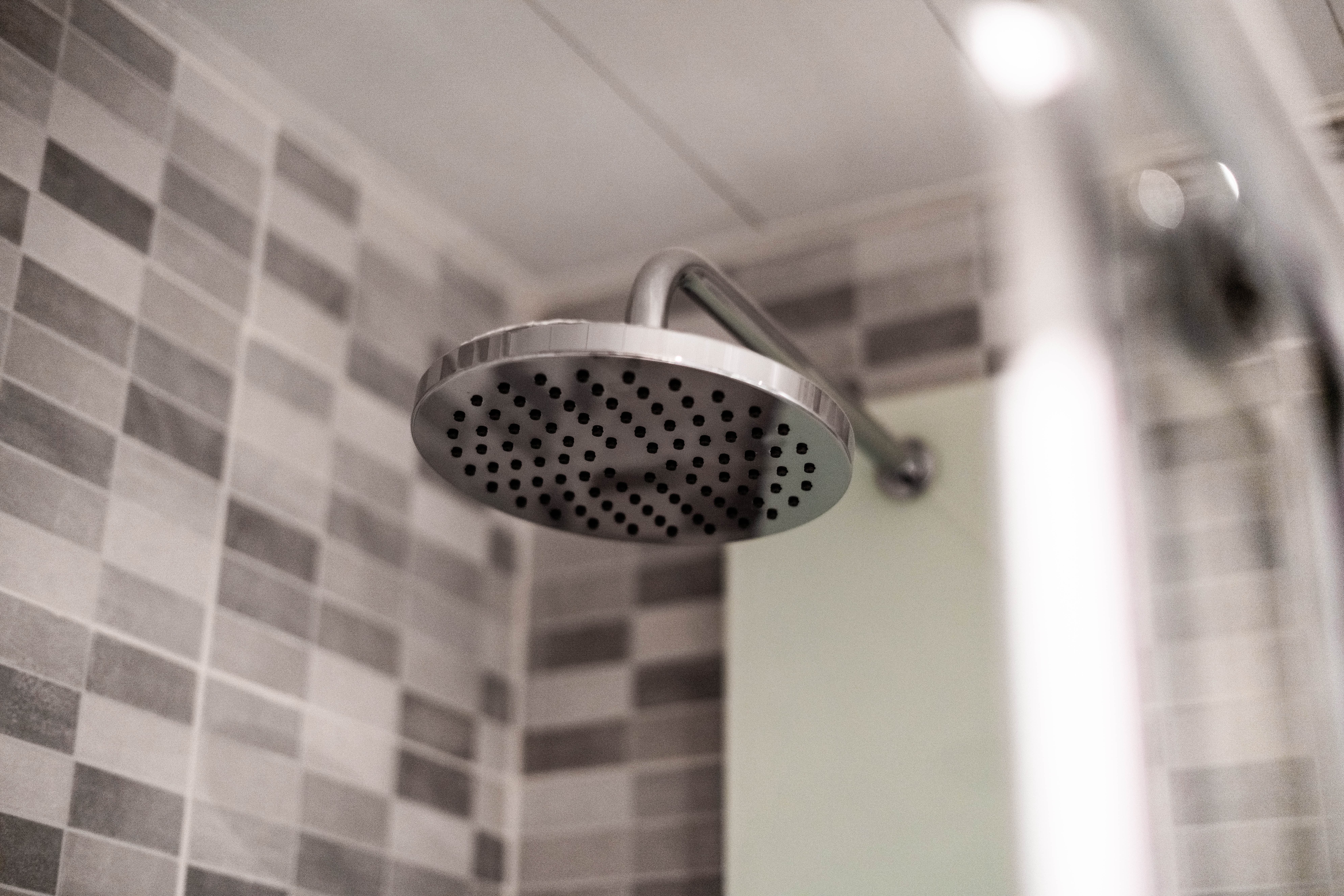 a-shower-head-in-a-tiled-background shower head in a tiled background